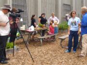 Hazel Dell: &quot;Garden Time TV's&quot; Jeff Gustin films William McClenathan interviewing Barbara Nordstrom at the Hazel Dell School and Community Garden for the Aug.