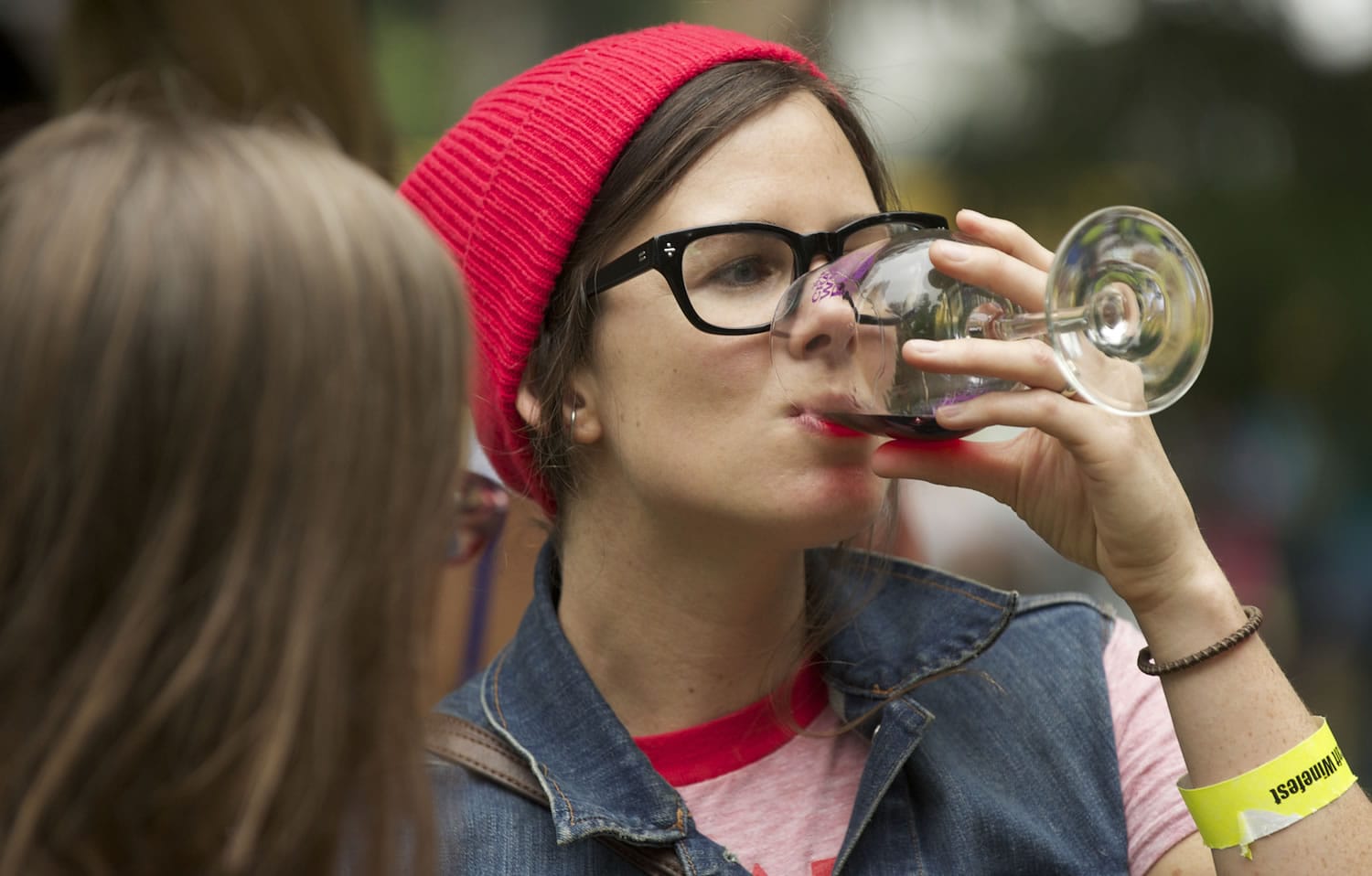 Vancouver native Mary Andersen, now living in Portland, samples wine from one of the 20 wineries participating in the Craft Winefest of Vancouver at Esther Short Park on Sunday.