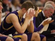 Columbia River's Isaiah Smith buries his head in a towel late in the fourth quarter as Lincoln High School goes on to beat Columbian River 55-35.