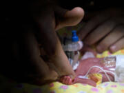 Tiffany Burril, 22, touches her daughter Harley Gulliksen on Monday.