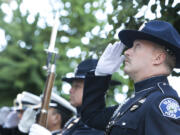 Honor Guards from the Vancouver Police and Fire Department watch as the flag is raised during the Patriot Day ceremony at City Hall on Tuesday.