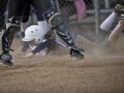 Skyview's Megan Settje slides past home plate after tagging for a run in a non-league softball game against Columbia River.