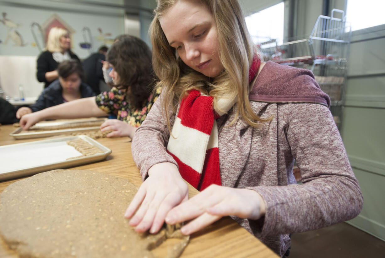 Autumn Kellems, 18, a student in the Futures program at Battle Ground Public Schools, makes doggie biscotti Thursday morning in the program&#039;s Battle Ground Barkery. Students with disabilities learn job skills and independent living skills in the program.