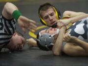 Referee Dan Johnson gets a closer look as Prairie's William Treadwell, top, takes control of Union's Carlos Simon.