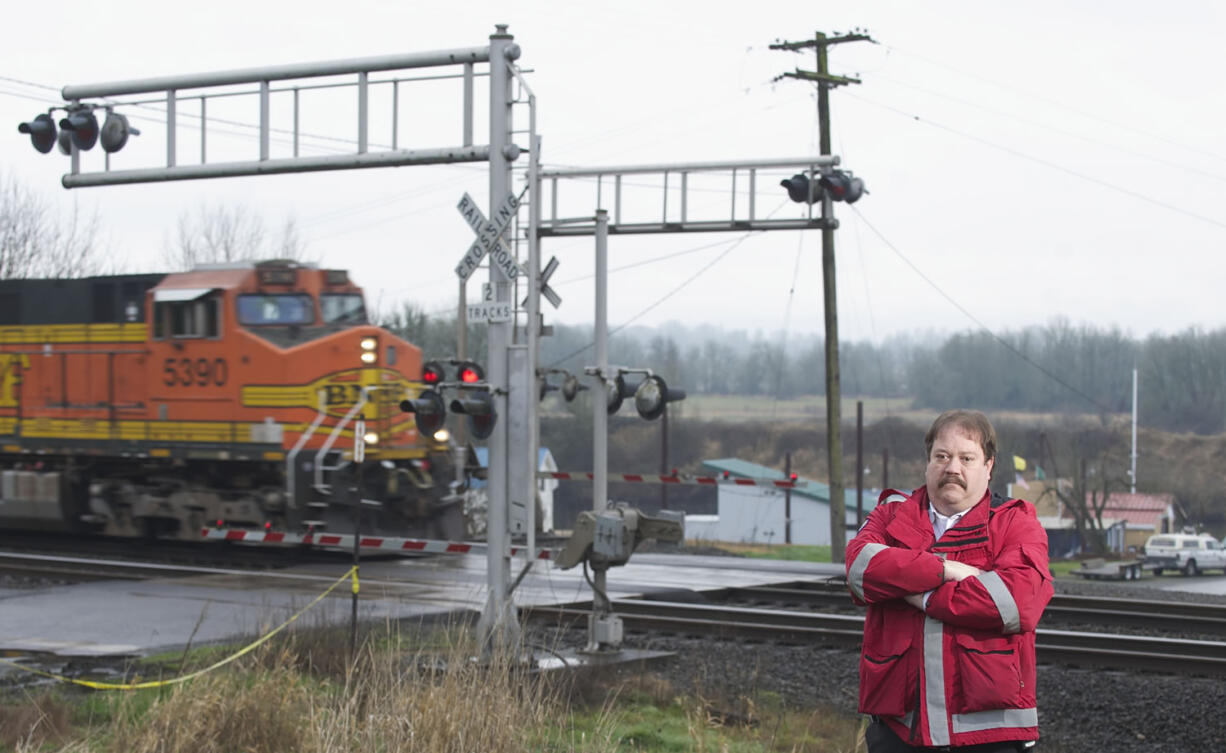 A freight train zooms past Ridgefield's Ash Street, near the Mill Street rail crossing.