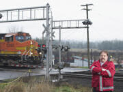 A freight train zooms past Ridgefield's Ash Street, near the Mill Street rail crossing.