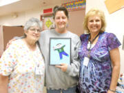 Lincoln: From left, Lincoln Elementary volunteers Nidia Charlton and Colleen Farrell, holding Flat Stanley, pose with first-grade teacher Kathy Johnson.