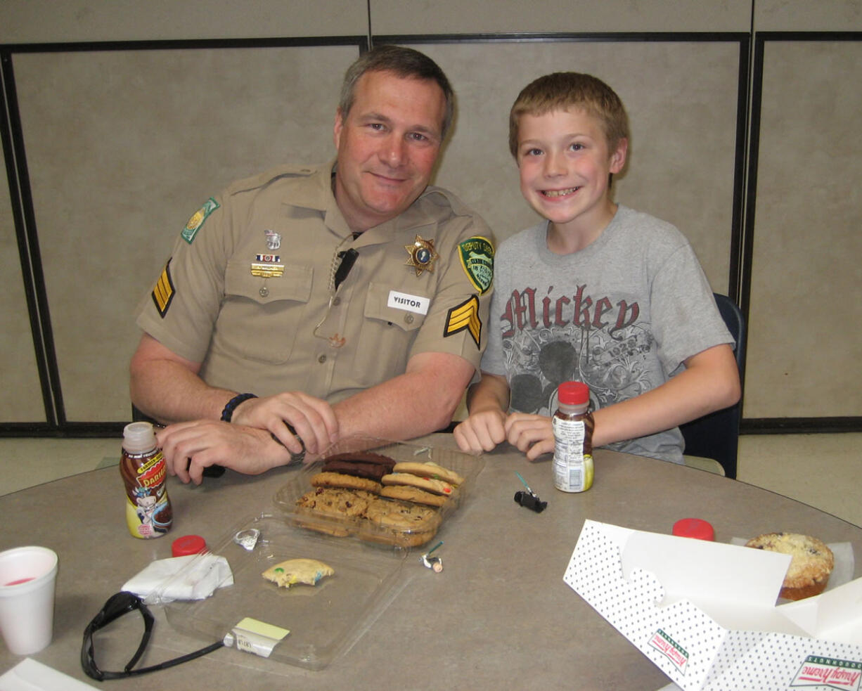 Northeast Hazel Dell: Sgt. Randon Walker chats with his pen pal Logan Collins, a fourth-grader at Sarah J.