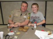 Northeast Hazel Dell: Sgt. Randon Walker chats with his pen pal Logan Collins, a fourth-grader at Sarah J.