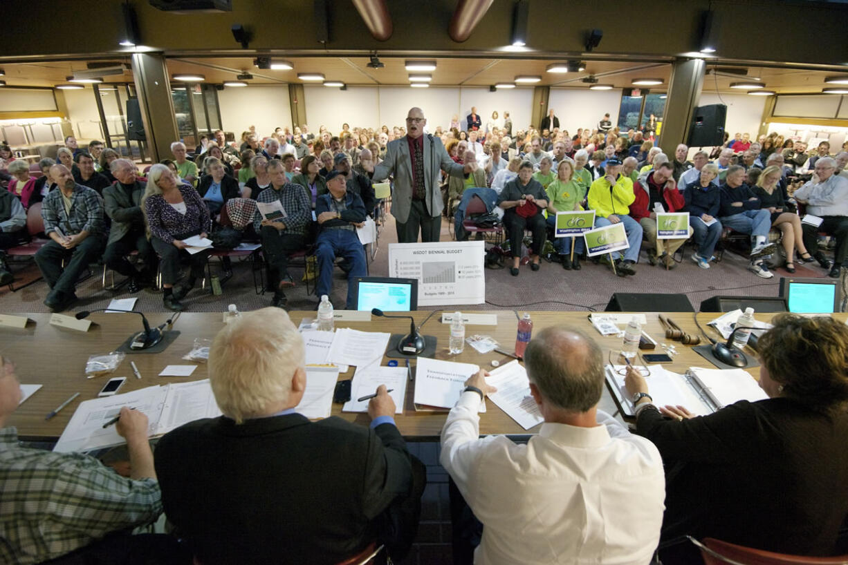 Chris Clifford, center, makes an impassioned appeal to politicians at a state transportation forum Monday in Vancouver to not raise taxes.