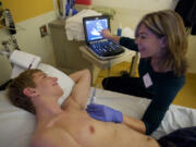 ECHO Tech Deborah Reyes performs an echocardiogram on Noah Morasch, 17, a junior at Mountain View High School, on Saturday.