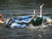 Vancouver residents Tyler Bacon, 10, left, and his brother Matthew Bacon, 13, cool off at Klineline Park on a hot day earlier this year.