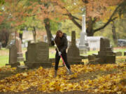 Photos by Steven Lane/The Columbian
Isabella Christner, 14, volunteering with the Fort Vancouver LEO Club, rakes leaves at the Old City Cemetery as part of the Make a Difference Day event Saturday.