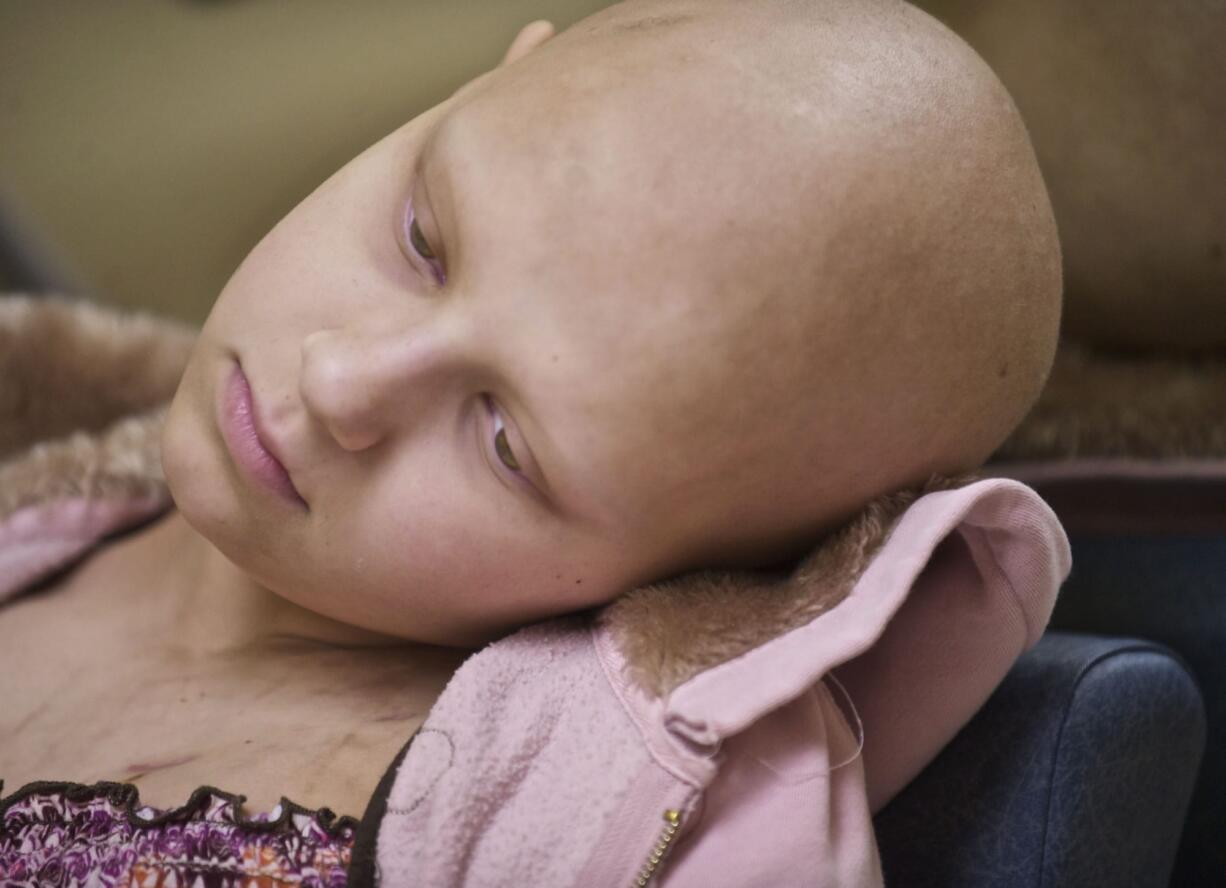 Caitlyn Lippolis of Vancouver rests for a moment after walking on her new prosthetic leg.