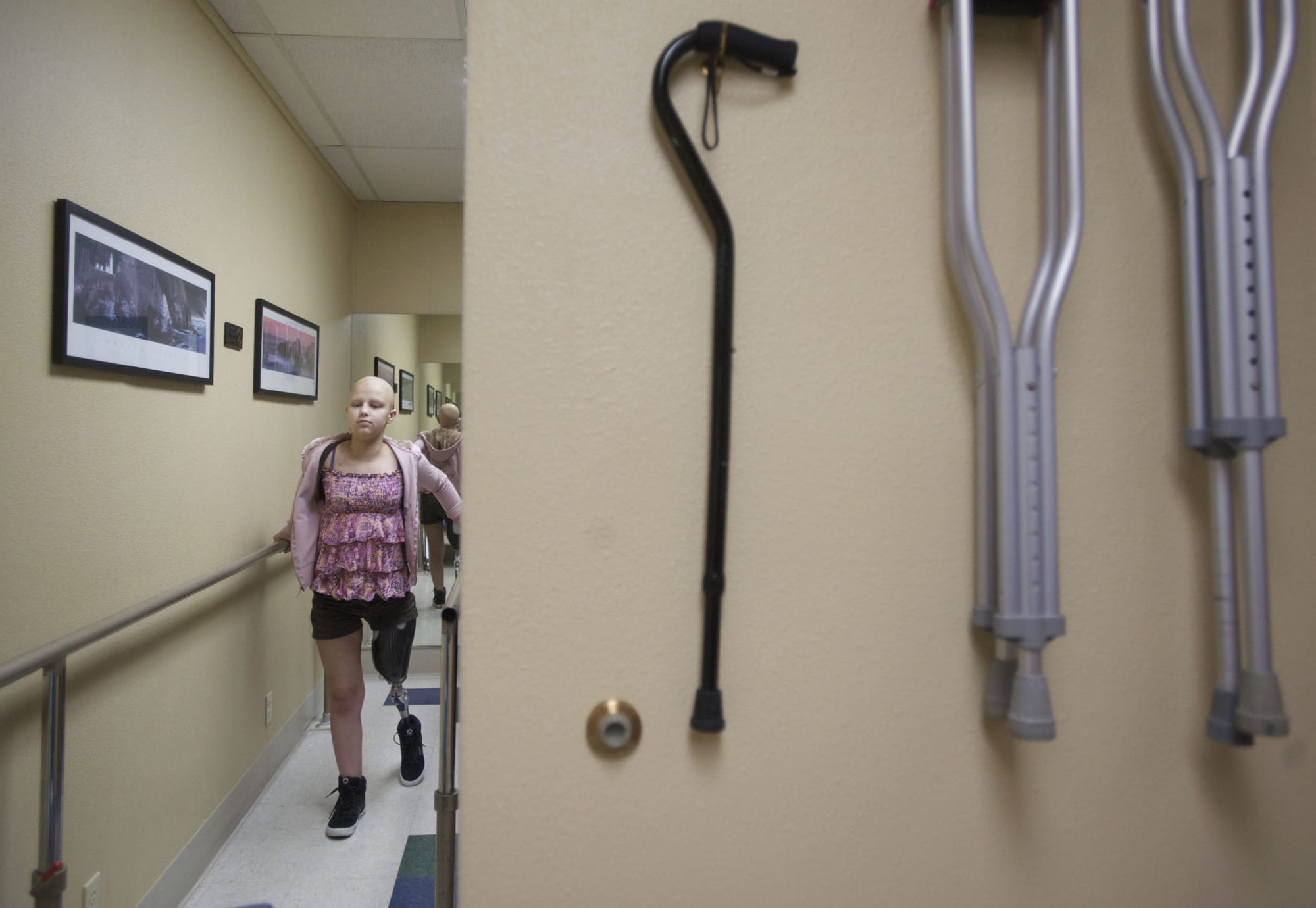 Caitlyn Lippolis of Vancouver takes her first steps with her new prosthetic leg at Artisan Technologies in Tualatin, Ore.