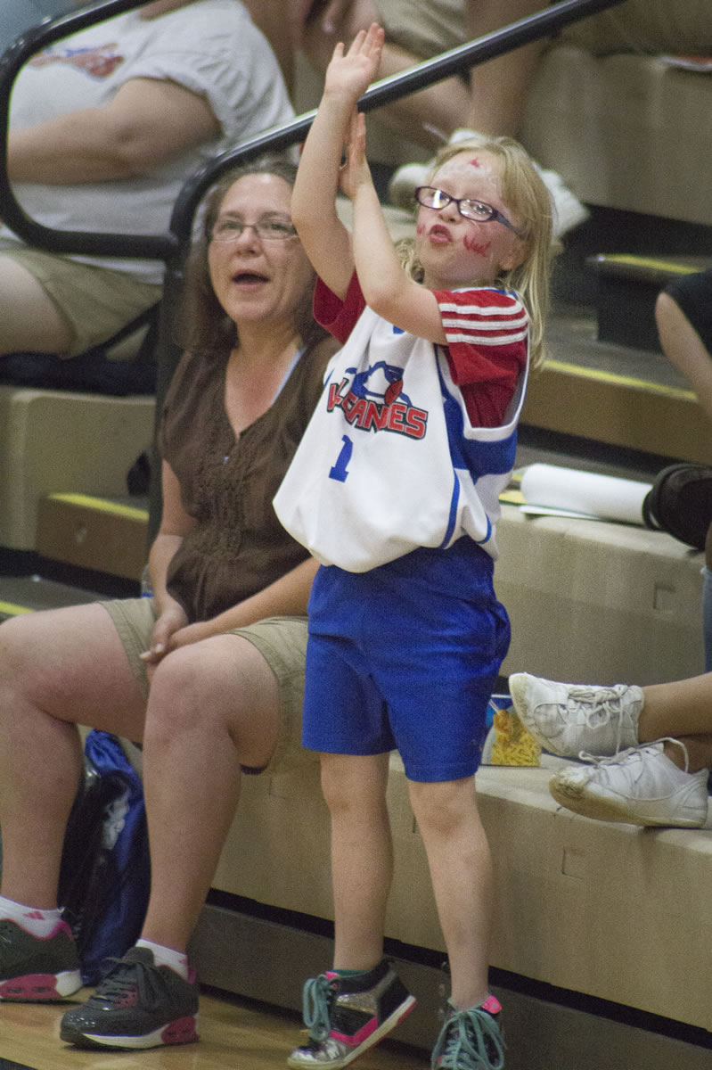 Madi Sibert, 8, gets into Fan Appreciation Night with the Vancouver Volcanoes by helping out during a free throw at the Volcanoes last home game of their season on Sunday, where they beat the Japan Nippon Tornadoes.