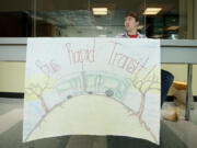 Volunteer Travis Cook sits at a table in support of bus rapid transit last year inside Clark College's Gaiser Hall.