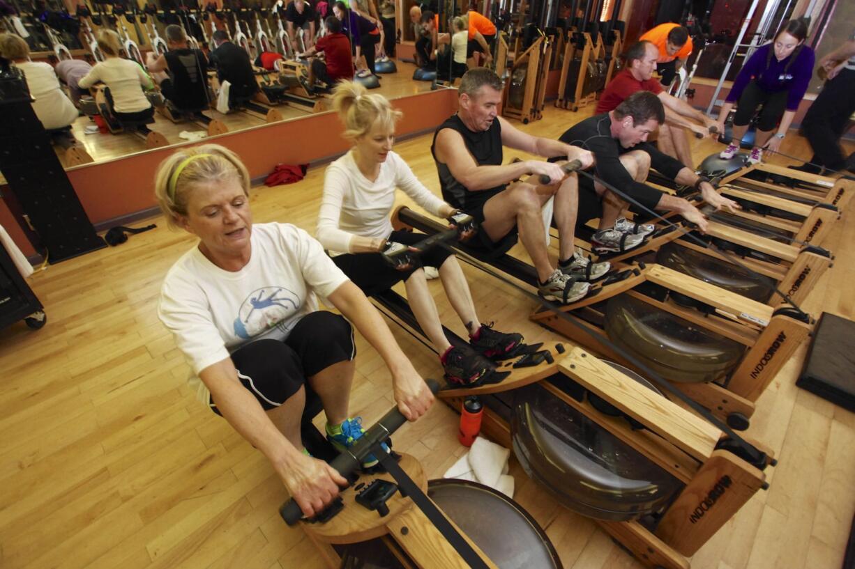 Diana Smith, left, works out on the rowing machine during the ShockWave class at Northwest Personal Training.