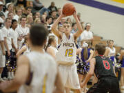 Columbia River&#039;s Jacob Hjort (12) passes to an open teammate past Camas defender Jake Hansel (0) in the second quarter Tuesday night, Dec. 1, 2015 at Columbia River High School gym.