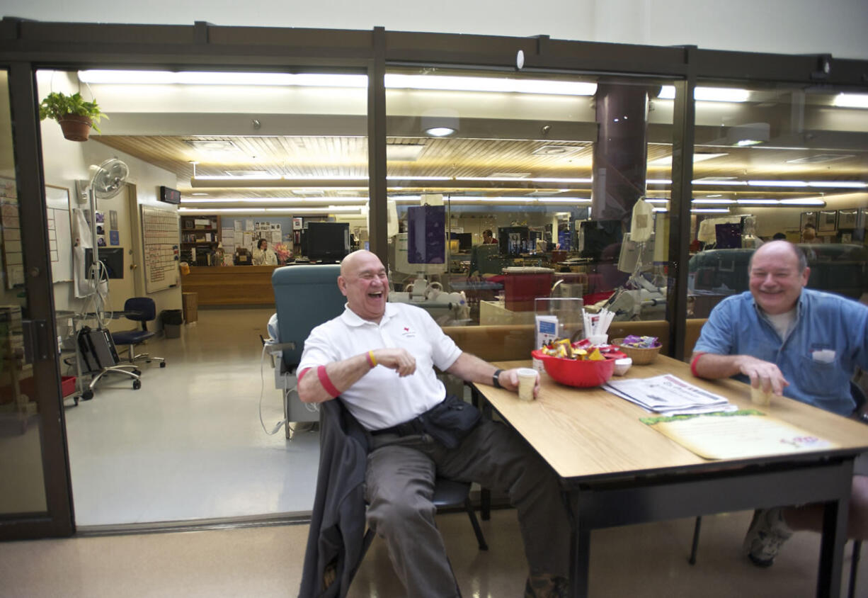 Childhood friends Bill McGinnis, left, and Teddy Peetz share a cup of coffee after donating blood platelets.