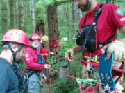 Mike Williams, 36, right, guides Nate Eterno, 35, near left, Steven Reese, 65, and Shawn Eten, 24, through the technicalities of setting up a highline tension rope system.