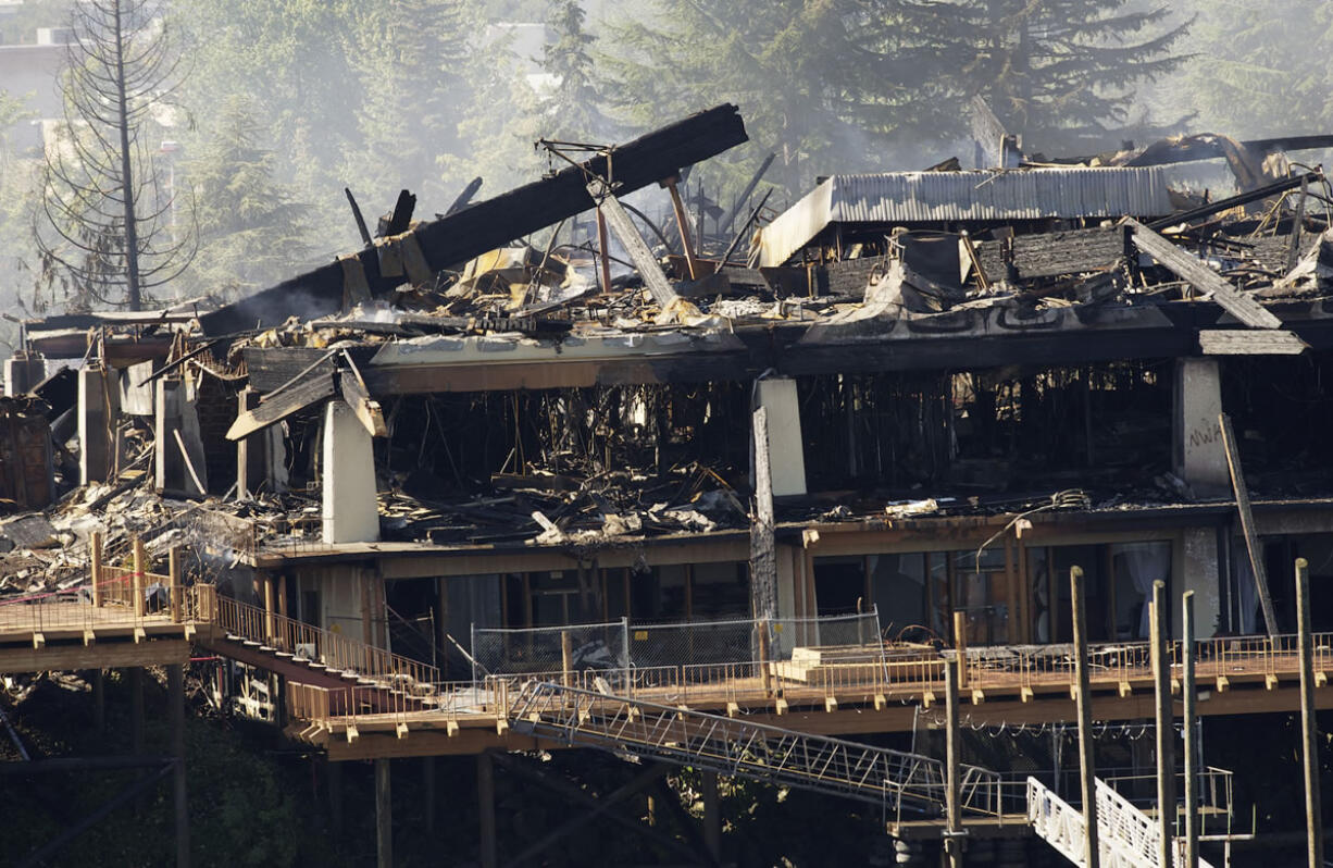 Ruins smolder Monday at the former Thunderbird on the River hotel on Hayden Island, just across the Columbia River from Vancouver.