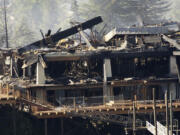 Ruins smolder Monday at the former Thunderbird on the River hotel on Hayden Island, just across the Columbia River from Vancouver.