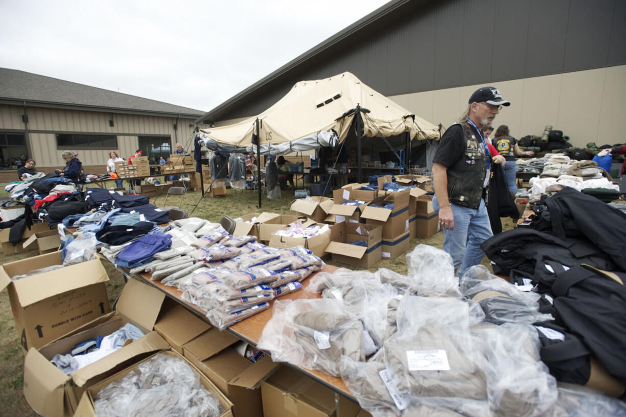 Veteran Cliff Nutting hands out clothing at the annual veterans stand-down event at the Armed Forces Reserve Center.