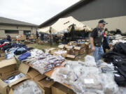 Veteran Cliff Nutting hands out clothing at the annual veterans stand-down event at the Armed Forces Reserve Center.