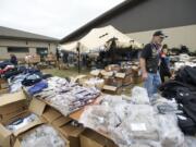 Veteran Cliff Nutting hands out clothing at the annual veterans stand-down event at the Armed forces Reserve Center in 2012.