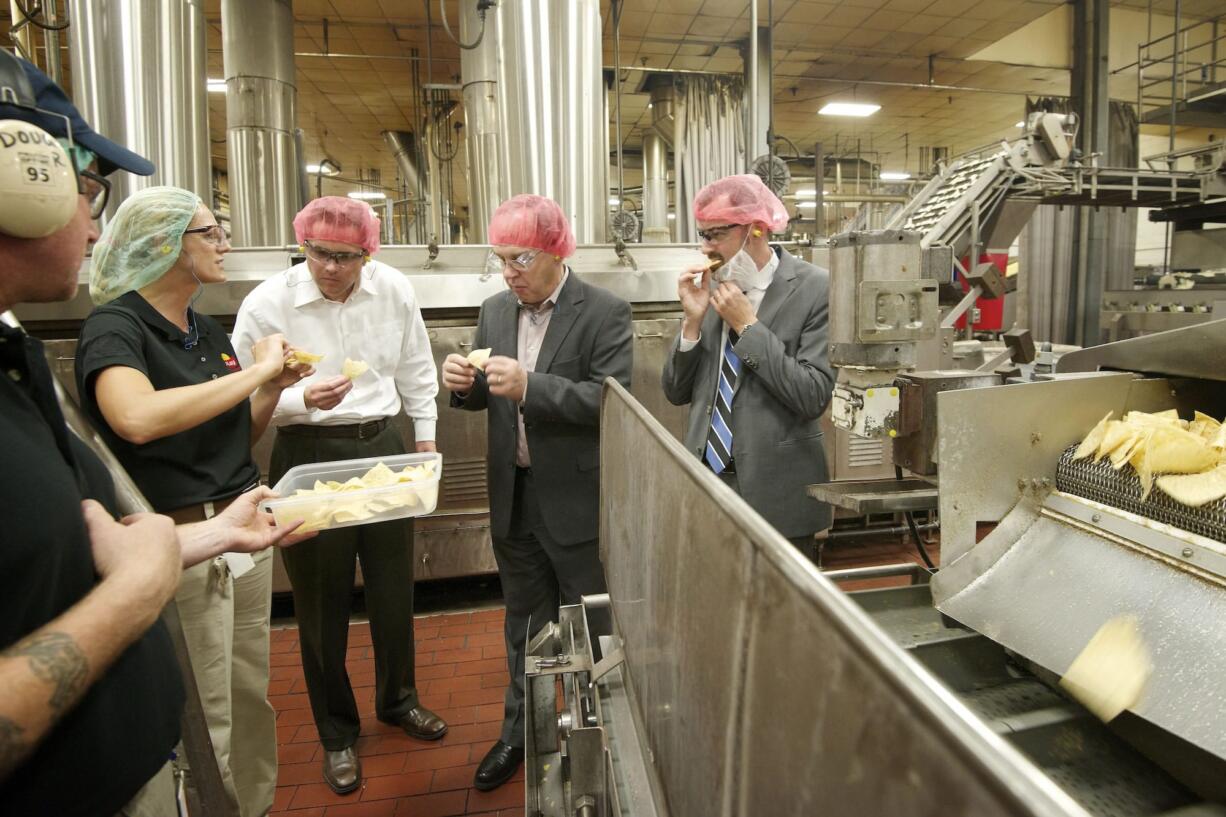 Misty Steele of Frito-Lay, left, talks about production and manufacturing processes with, from left, Peter King of the Columbia River Economic Development Council, Vancouver City Councilor Jack Burkman and Vancouver City Manager Eric Holmes.