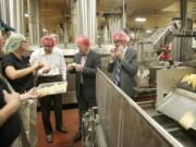 Misty Steele of Frito-Lay, left, talks about production and manufacturing processes with, from left, Peter King of the Columbia River Economic Development Council, Vancouver City Councilor Jack Burkman and Vancouver City Manager Eric Holmes.