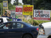 Midday traffic passes political campaign sign at the intersection of 134th Street and Highway 99.