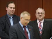 Clark County Commissioner David Madore, center, reads a proclamation at a public meeting in April 2013 as commissioners Steve Stuart, left, and Tom Mielke listen.