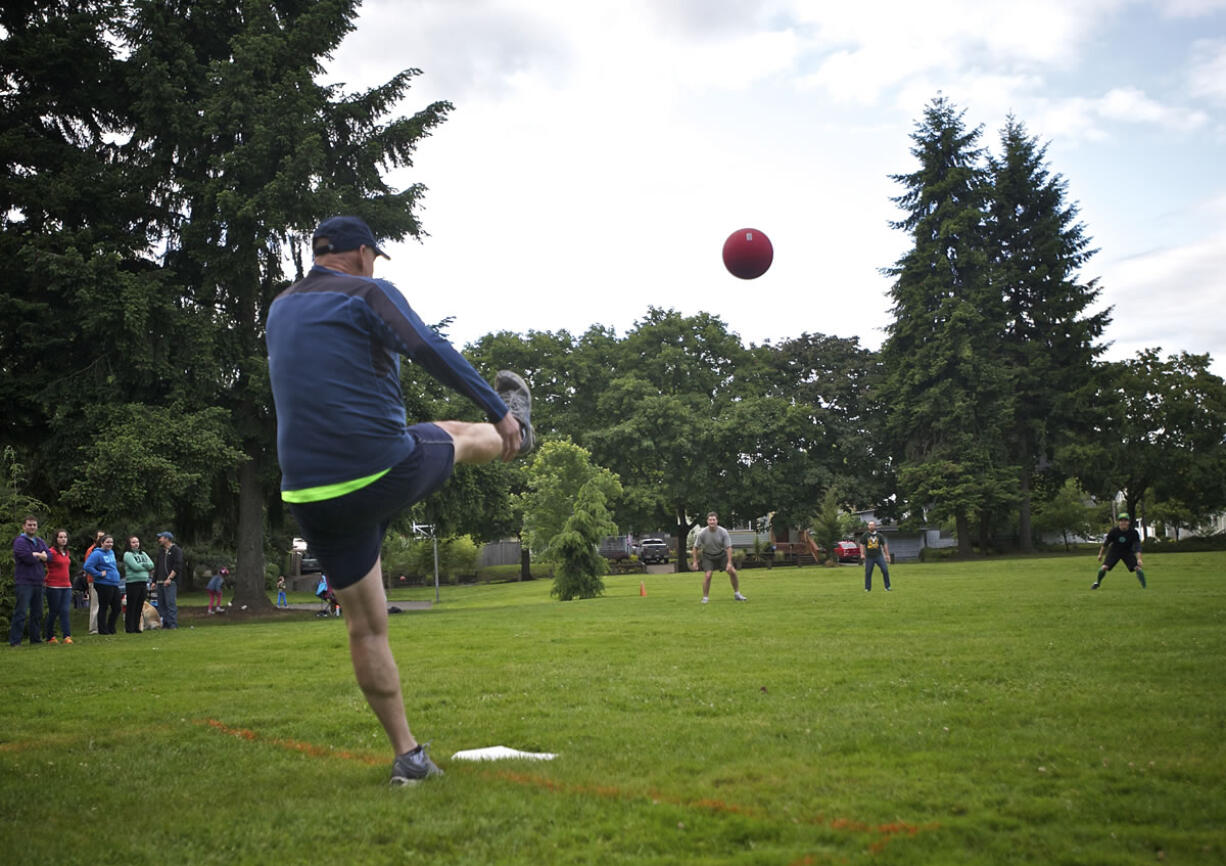 A Hough Shamrocks team member boots the ball against the Carter Park Kickers at an adult kickball league match at John Ball Park.