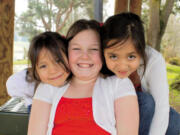 Elianna Neumann, center, with her sisters Marisol (left) and Lluliza.