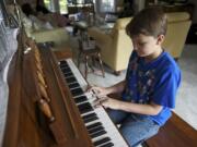 Cole Hancock, 10, still has trouble saying and remembering some words, but he remembers the piano pieces that he's learned.