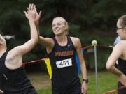 Prairie's Nicole Goecke celebrates with teammates after winning the 3A district cross country title at Lewisville Park on Thursday.