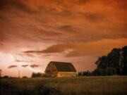 A lightning bolt lights up the sky over an old barn in Ridgefield early this morning. A total of 19 lightning strikes reached the ground in Clark County, according to the National Weather Service in Portland. The photo was shot at 2 a.m.