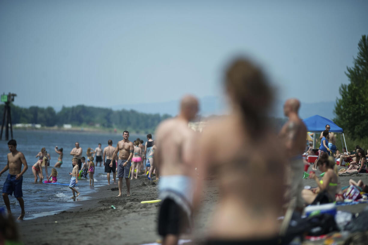 A crowd enjoys the sunshine at Frenchman's Bar Park on Sunday.