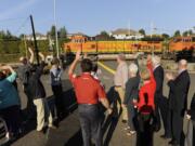 Neighbors and city staffers celebrate as a coal train passes an upgraded crossing at Southeast 147th Avenue on Wednesday, the first day quiet zones were in effect at three public crossings.