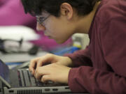 Juan Aguilar, 15, a visually impaired high school student at Washington State School for the Blind, uses a special video conferencing program for an algebra lesson.