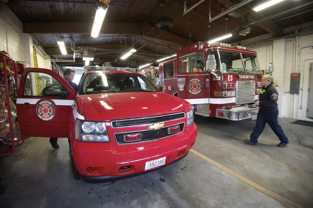 Captain and paramedic with the Vancouver Fire Department, Bob Carroll, left, and firefighter Natalie Newgent prepare to leave Station 3 on an allergic reaction call to Eleanor Roosevelt elementary.