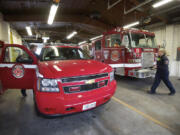 Captain and paramedic with the Vancouver Fire Department, Bob Carroll, left, and firefighter Natalie Newgent prepare to leave Station 3 on an allergic reaction call to Eleanor Roosevelt elementary.