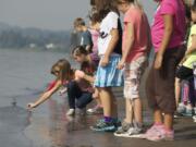 Fourth-graders from Grass Valley Elementary check the water temperature of the Columbia River at Captain William Clark Park Friday.