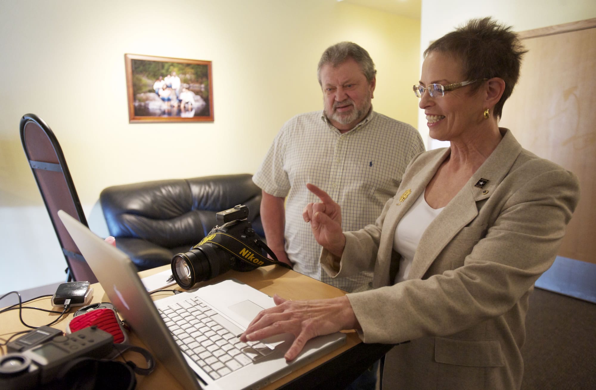 Navy veteran Bob Fry and Vancouver photographer  Kate Singh check out an image of Fry's tattoo after a photo session.