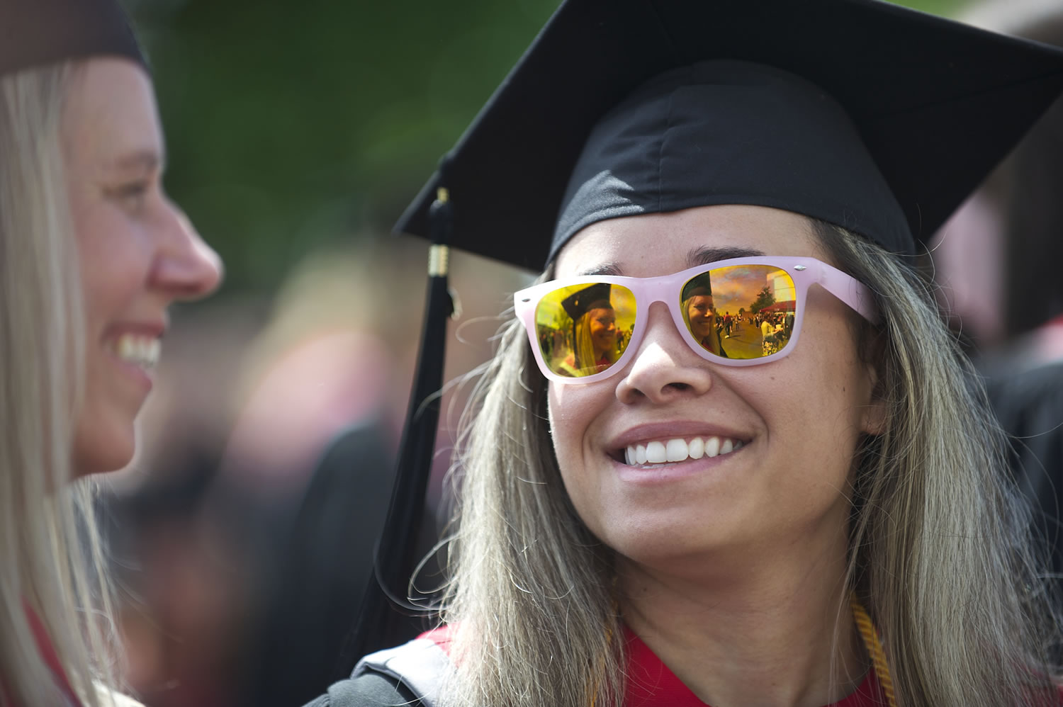 Elizabeth Roe, 27, of Chehalis, right, reflects well on a fellow graduate -- who happens to be her mother, Jan Roe, 52 -- before the Washington State University Vancouver commencement ceremony at the Sleep Country Amphitheater on Saturday. The younger Roe is is receiving a B.A. in social science and her mother is receiving a B.A. in social science and a B.S.