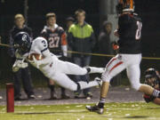 Skyview's Daniel Thompson dives into the end zone for a touchdown against Battle Ground, Friday.