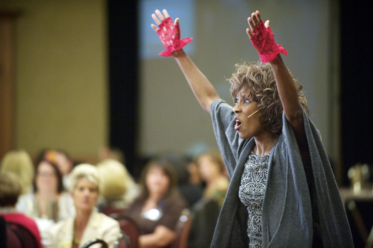 Wambui Bahati delivers a performance of her one-woman show, &quot;I Am Domestic Violence,&quot; at a YWCA fundraising luncheon in downtown Vancouver on Wednesday.