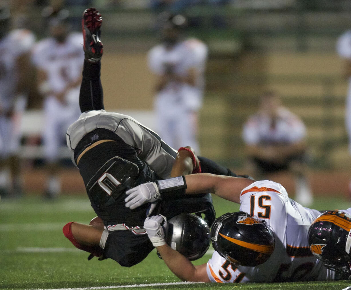 Union's Brendin Quinn is taken down by Battle Ground's Forrest Mays in the second half at McKenzie Stadium on Friday.